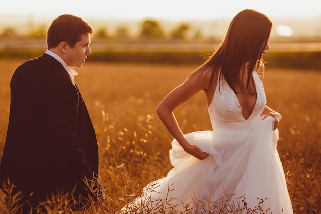 "Groom and bride in field"