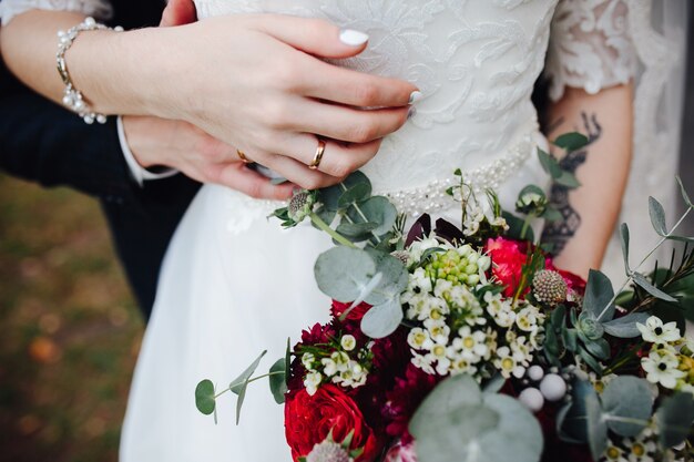 Groom and bride holding hands