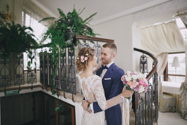 Free photo groom and bride in a hotel