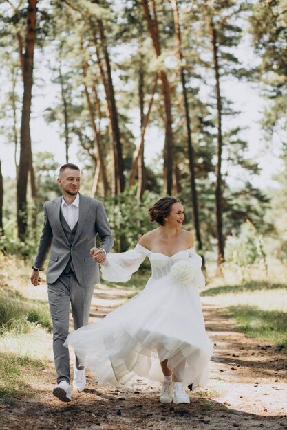 Groom and bride on their wedding day in forest