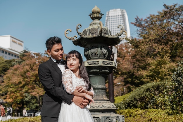 Groom embracing the bride outdoors