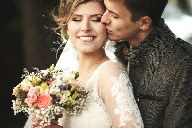 Groom embracing his happy wife