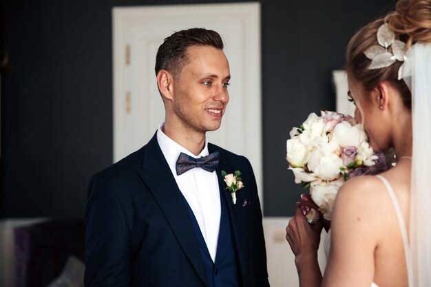 Groom is looking at his beautiful bride