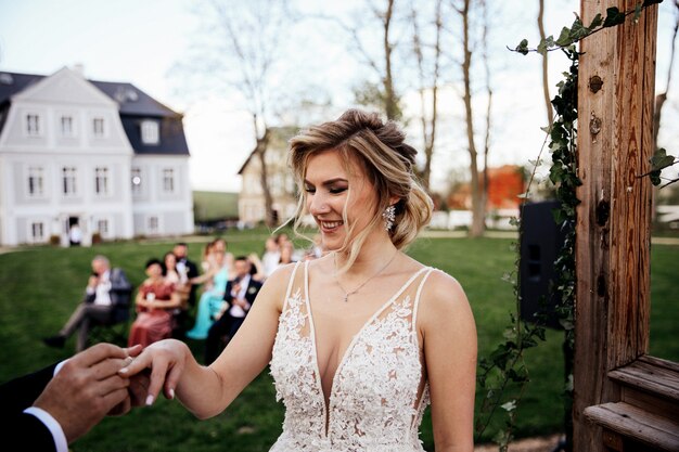 Groom is putting the wedding ring on the bride's finger