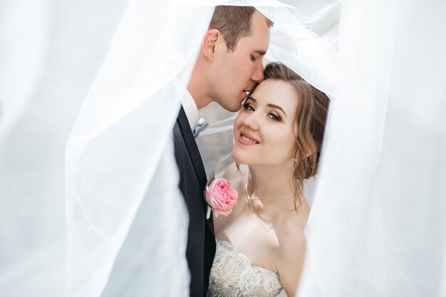 The groom kisses his beloved wife