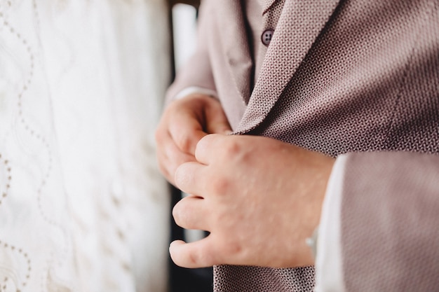 Groom meeting, details, jacket, shoes, watches and buttons on the wedding day