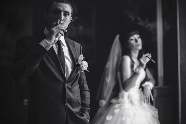 Free photo groom puffing a cigar