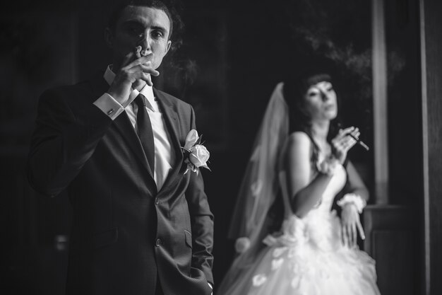 Groom puffing a cigar