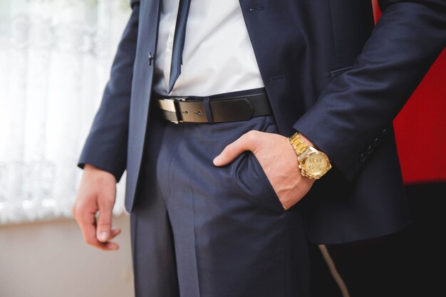 Groom's left hand in his pocket