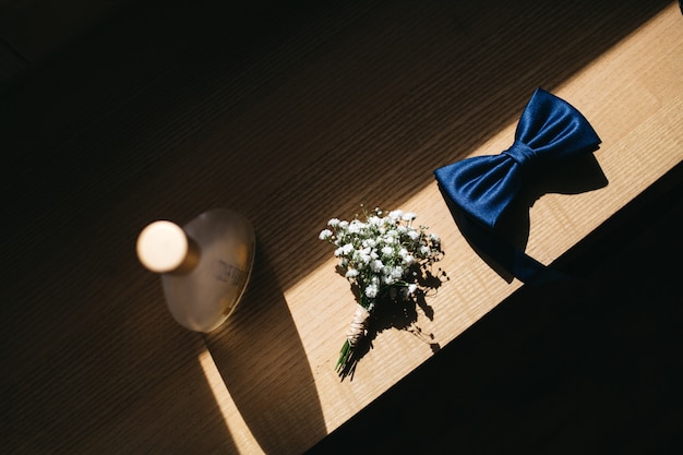 Groom's wedding details lie on a table