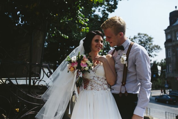 Groom smiling at his wife