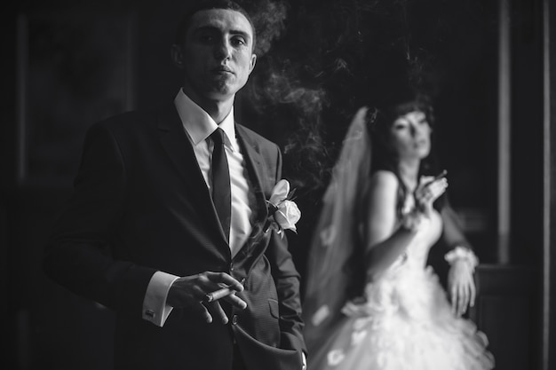 Groom smoking cigar