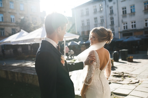 Free photo groom touching his girlfriend from behind