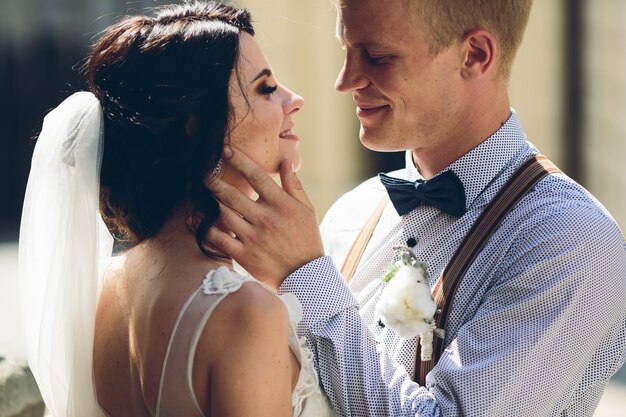 Groom touching his wife's face