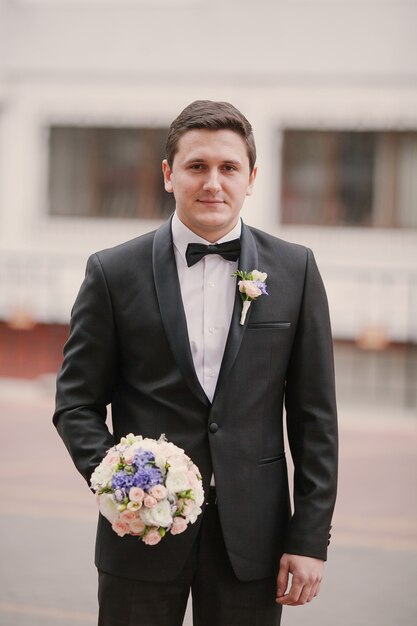 Groom with a bouquet of flowers