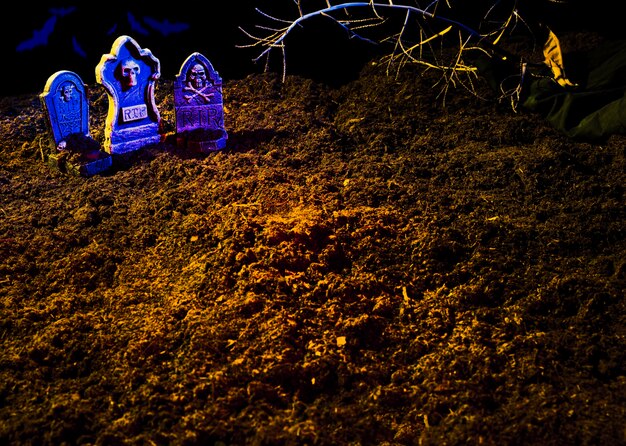 Ground with graves and shining violet headstones