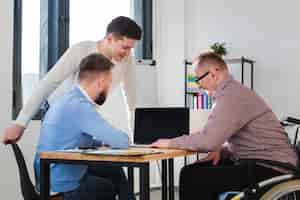Free photo group of adult men working together at the office