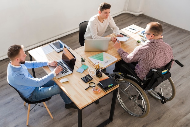 Group of adult men working together at the office