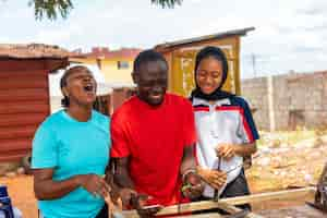 Free photo group of africans feeling excited about what they saw on their cellphone