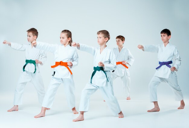 The group of boys and girl fighting at Aikido training in martial arts school. Healthy lifestyle and sports concept