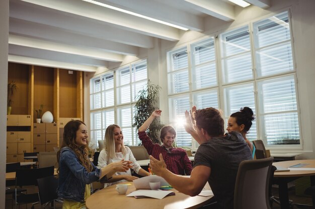 Group of business executives giving high five