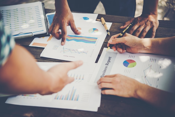 Free Photo group of business people analysis with marketing report graph, young specialists are discussing business ideas for new digital start up project.