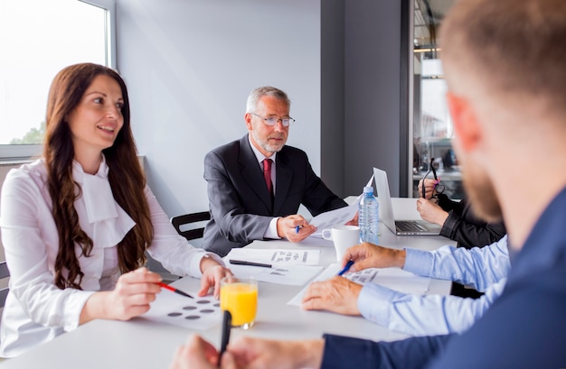 Group of business people busy discussing financial matter during meeting