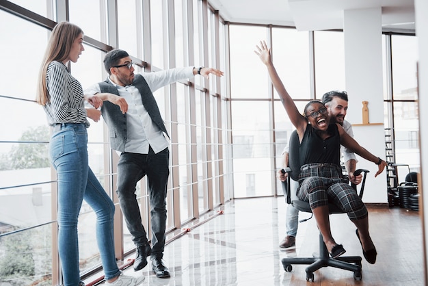 A group of business people having fun, at the office.