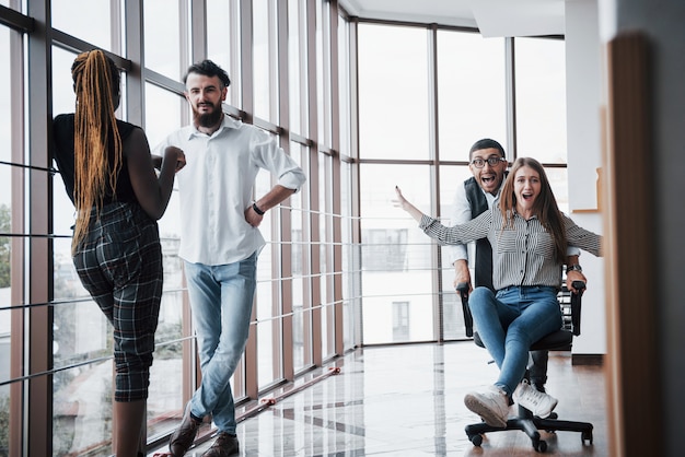 A group of business people having fun, at the office.