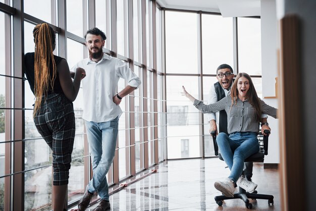 A group of business people having fun, at the office.