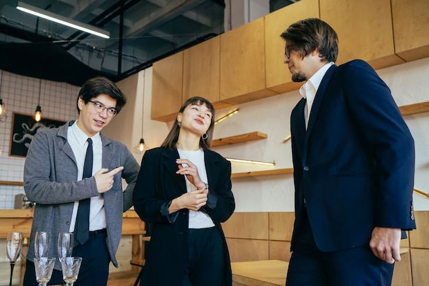 Group of business people in a meeting standing grouped in a office