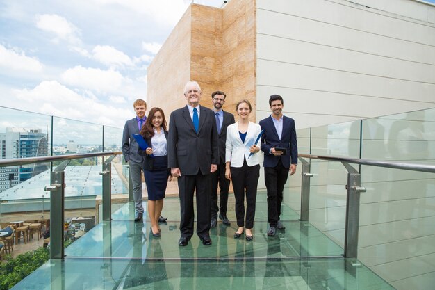 Group of business people walking on a glass walkway