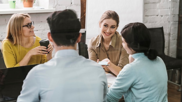 Free photo group of businesspeople during a meeting presentation