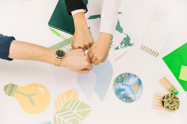 Group of businesspeople fist bumping over desk Free Photo