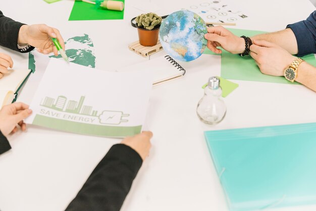 Group of businesspeople working on energy saving over desk