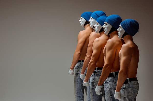 Free photo the group of caucasian men in white masks and hats, jeans