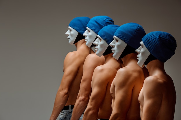 Free photo the group of caucasian men in white masks and hats, jeans