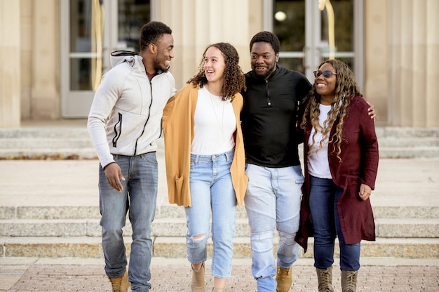 Group of cheerful friends joking and laughing together