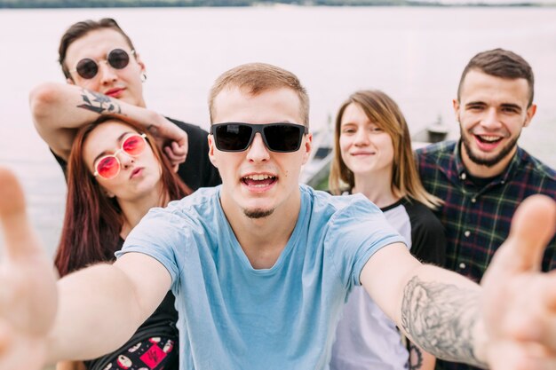 Group of cheerful friends taking selfie