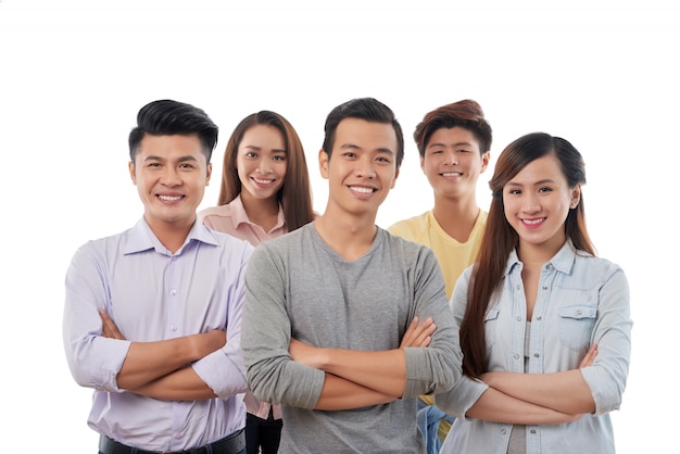 Group of cheerful young casually dressed men and women posing