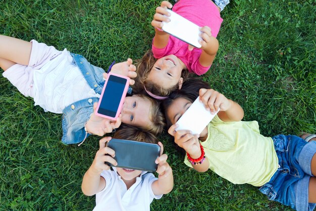 Group of childrens taking a selfie in the park.