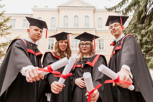 Group of colleagues with diploma