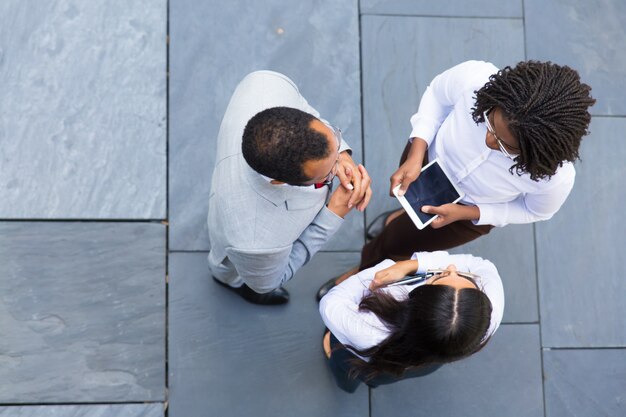 Group of confident workers talking outdoors