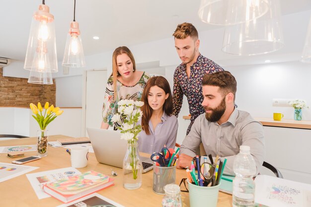 Group of coworkers watching laptop