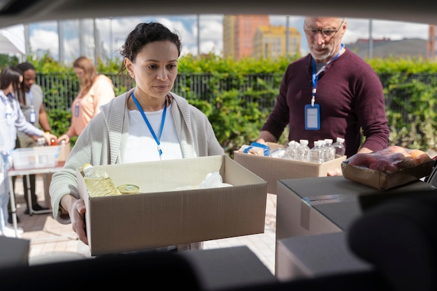 Group of different people volunteering at a foodbank for poor people