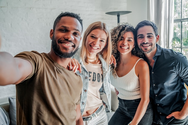 A group of diverse friends having fun while taking selfies together. Friends concept.