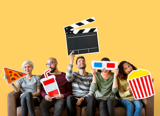 Group of diverse friends holding movie emoticons