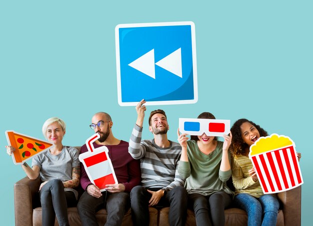 Group of diverse friends holding movie emoticons