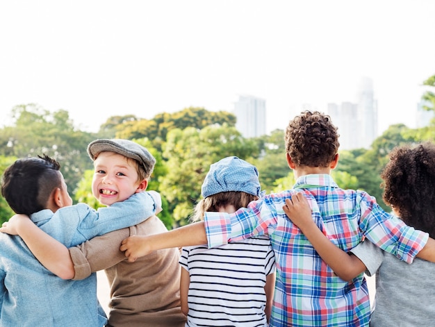 Free photo group of diverse kids back turned arms around together