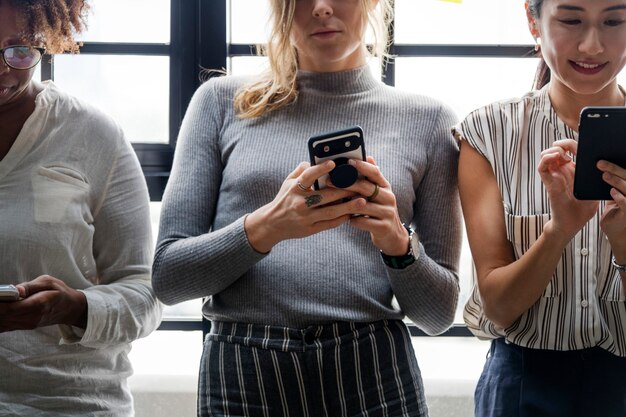 Group of diverse people using smartphones